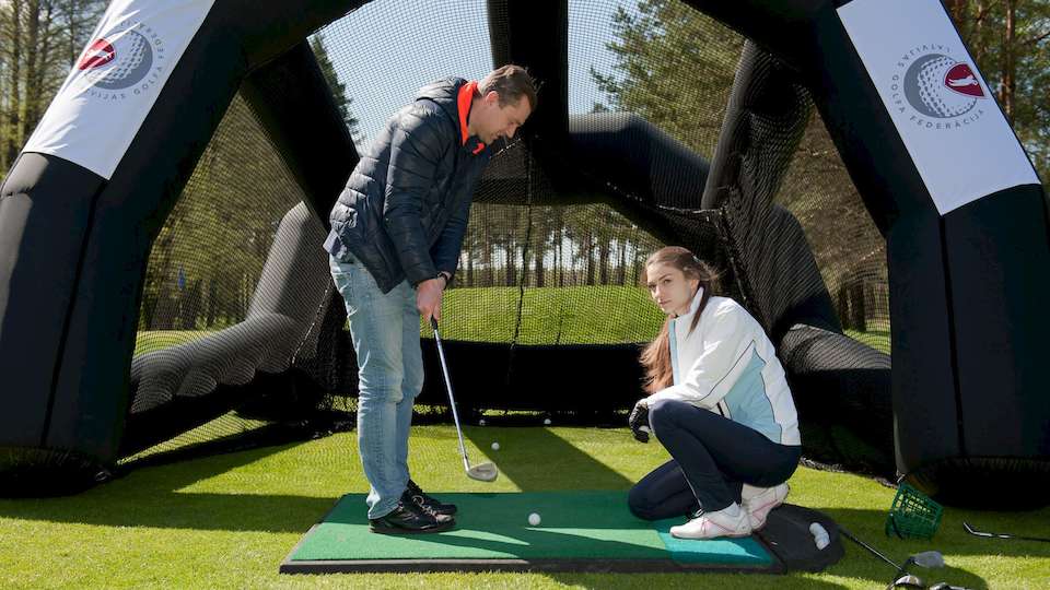 Golf competition together with experienced golfer