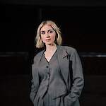 An energetic small woman in her 30s with dark blonde hair.